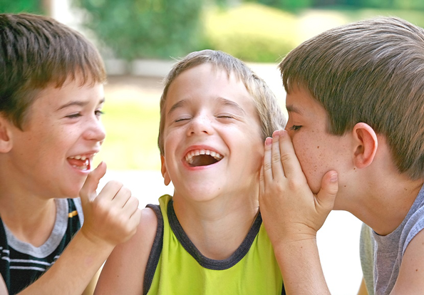 kids laughing and talking to each other outside.